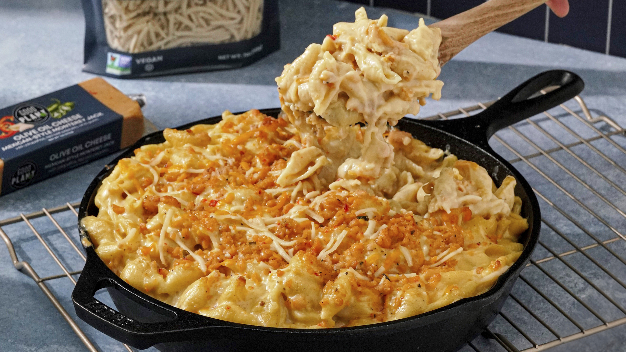 Gooey mac and cheese in cast iron pan made with GOOD PLANeT Foods Olive Oil Cheese